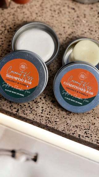 Coconut Kiss Shampoo Bar and Coconut Kiss Conditioner Bar tins side by side